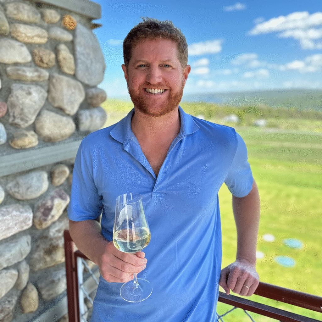 Wine club manager Benn with a glass of wine